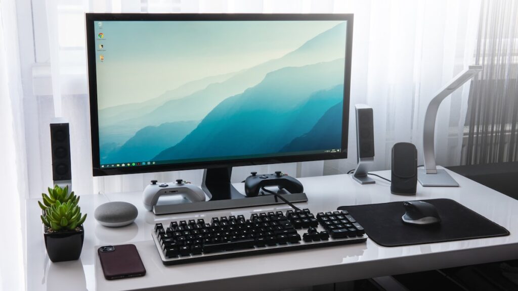 Keyboard beside a desktop computer