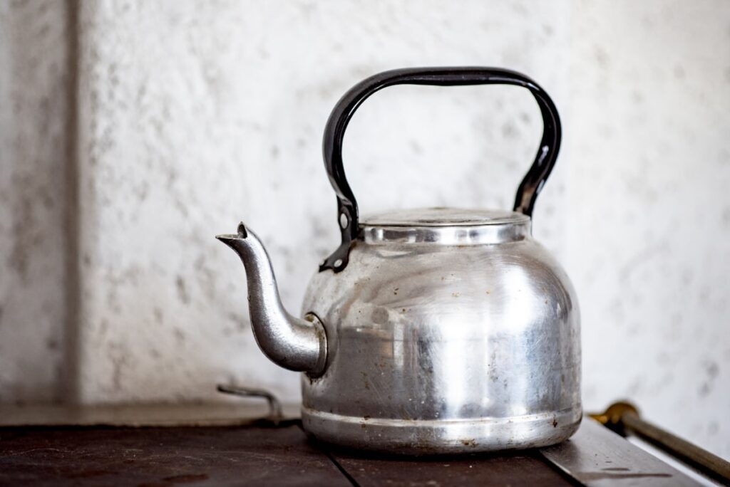 Stainless steel electric kettle on a wooden table