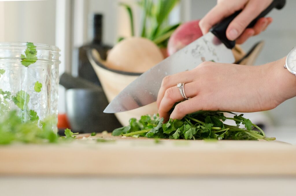 Person cutting vegetables with a kitchen knife