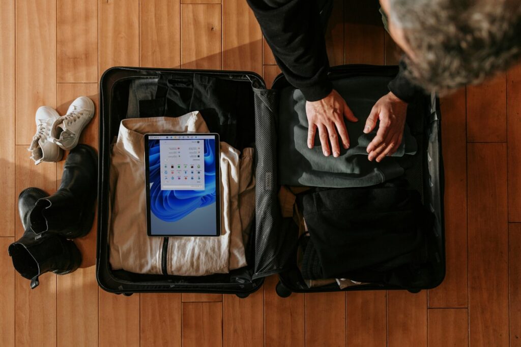 Overhead view of a person packing a suitcase