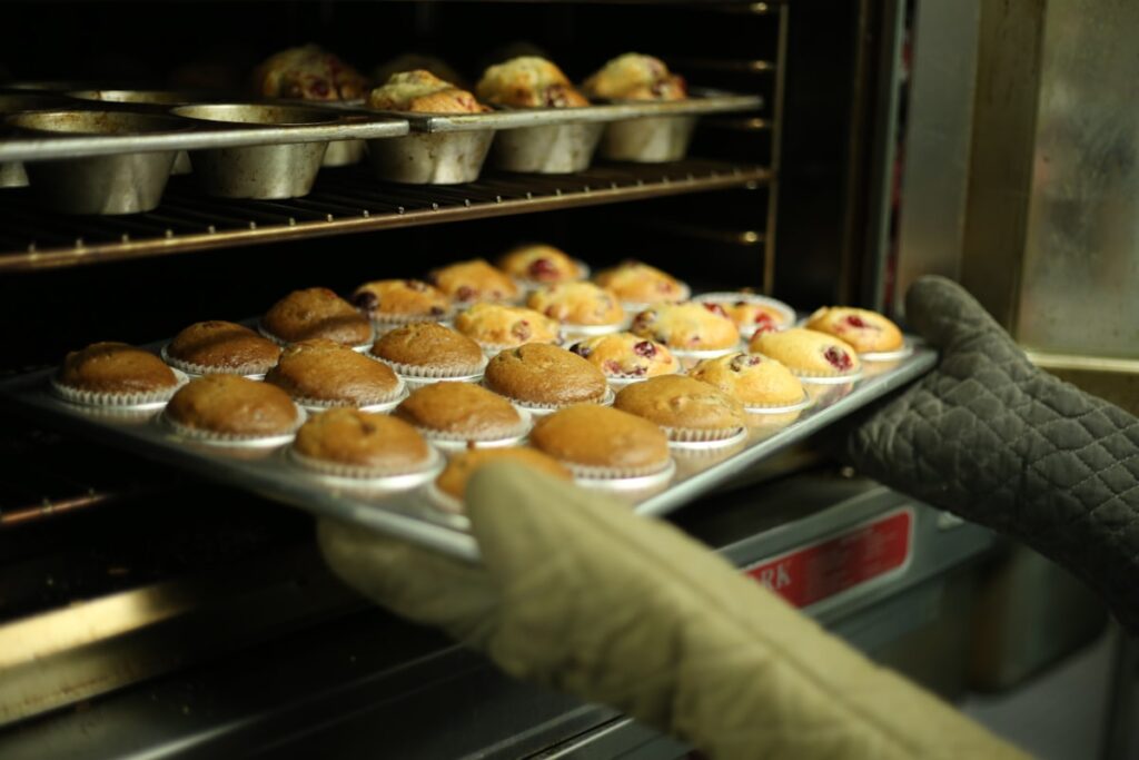 Fresh muffins on a baking tray