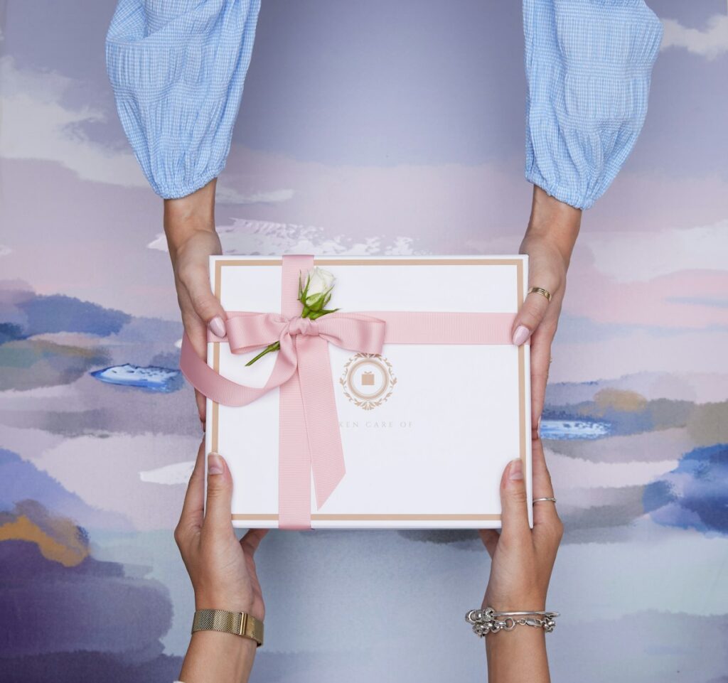 Hands exchanging a wrapped gift box