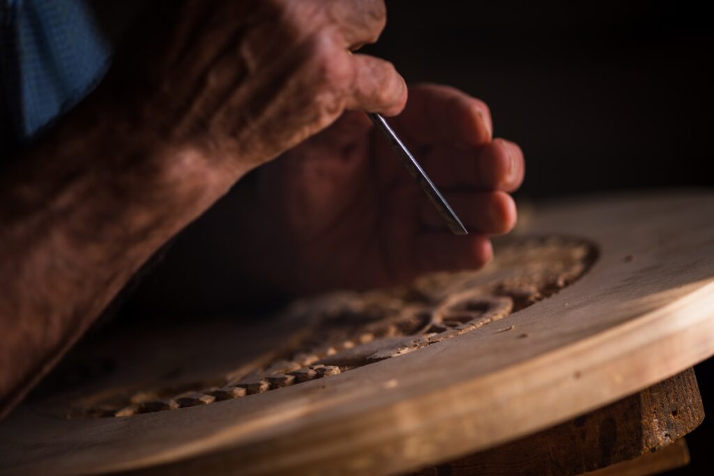 Person hand-carving a piece of wood
